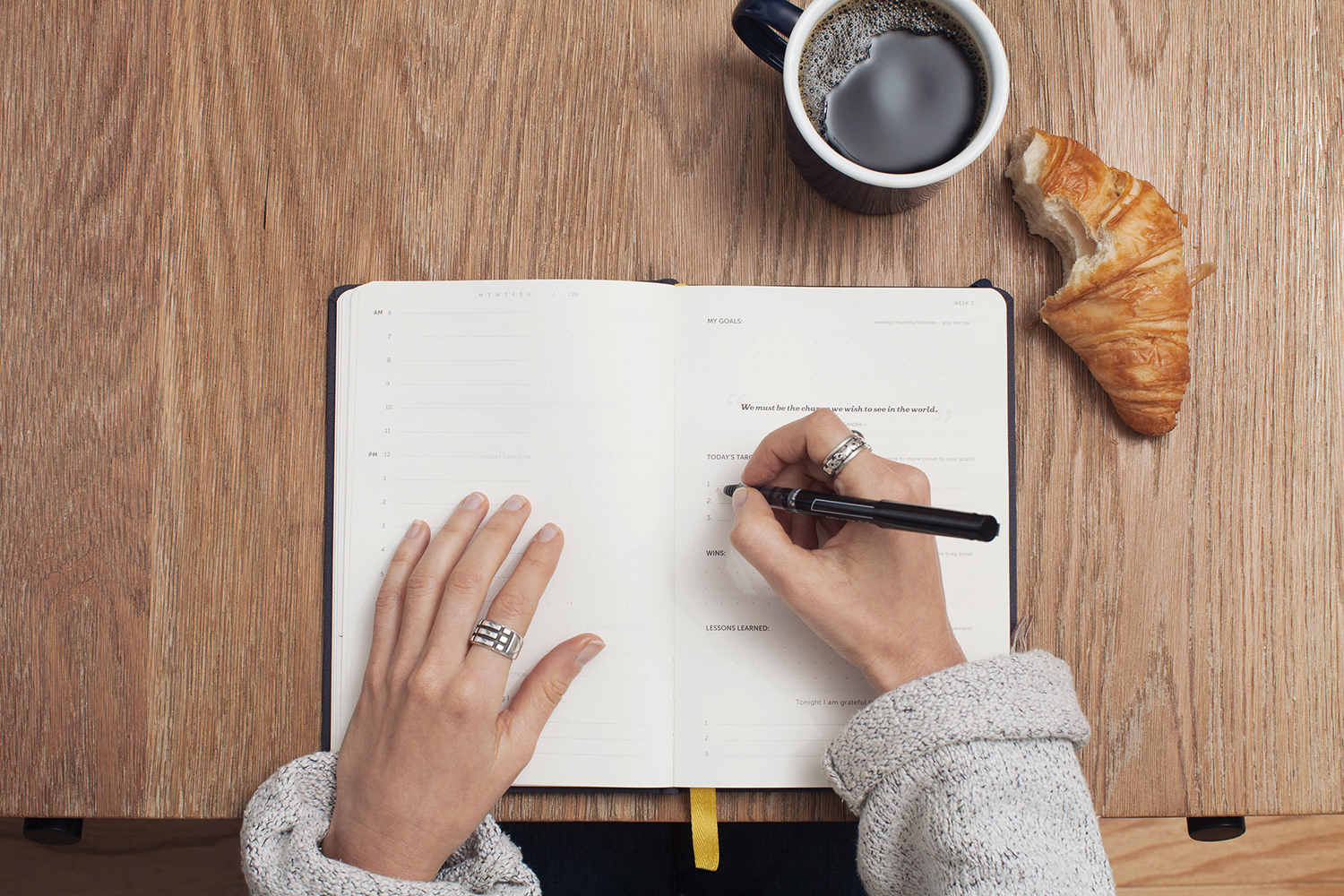 Woman writing in notebook, how to keep a food journal for IBS symptoms